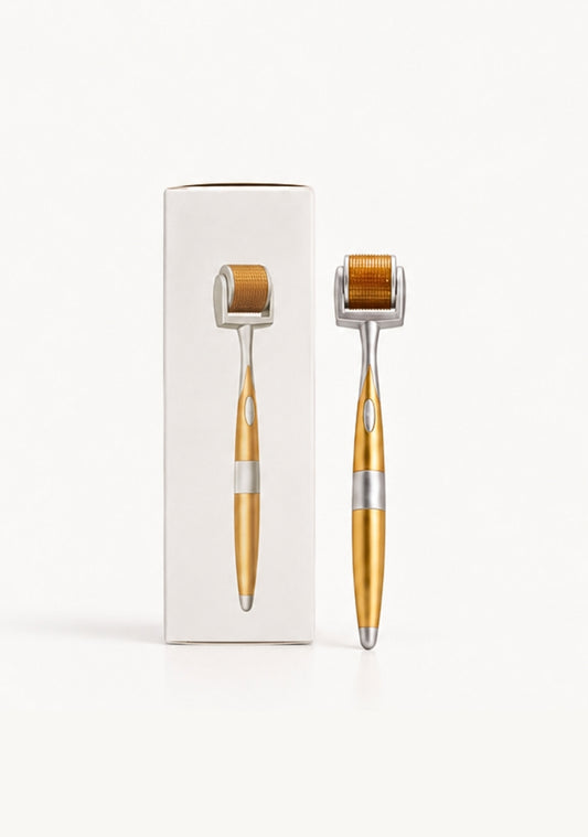 ÜL Care gold derma roller with silver accents displayed beside its white packaging on a clean background.